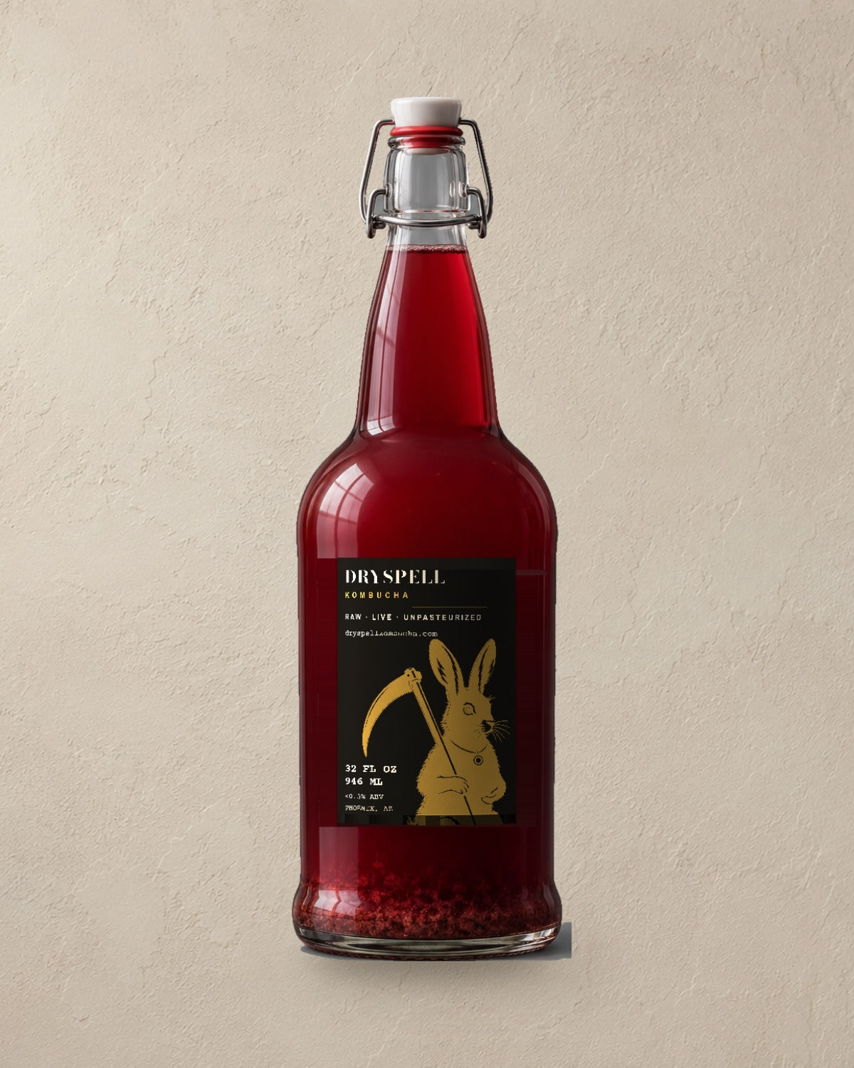 Dryspell 32 oz swing-top bottle, ruby kombucha, on plaster