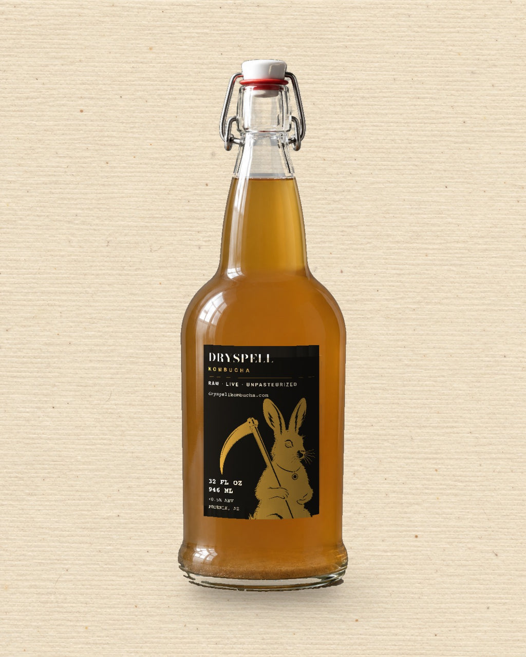 Dryspell 32 oz swing-top bottle, amber kombucha, on cream