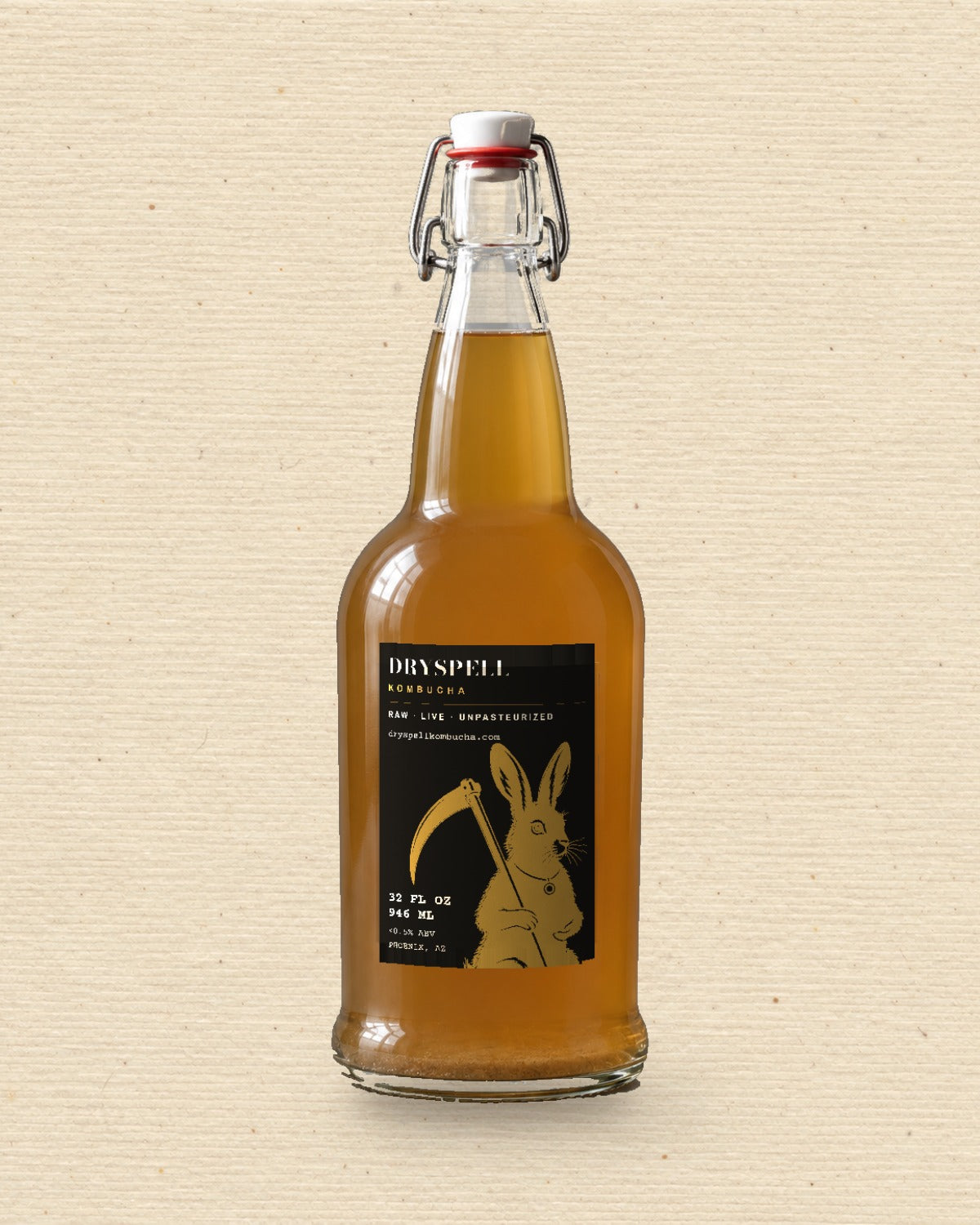 Dryspell 32 oz swing-top bottle, amber kombucha, on cream