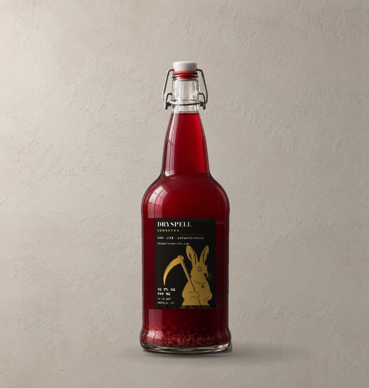 A 32 oz Dryspell swing-top bottle of red kombucha against a plaster wall